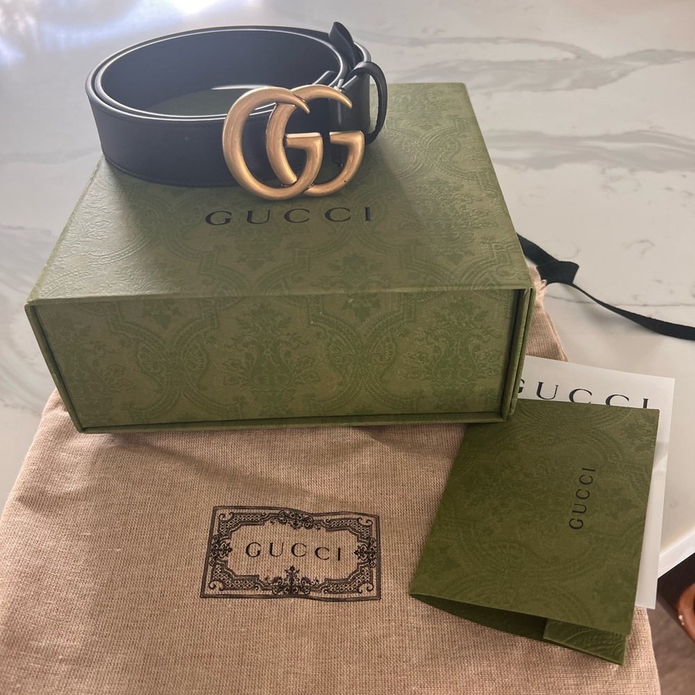 Gucci belt with receipt, duster bag and box.